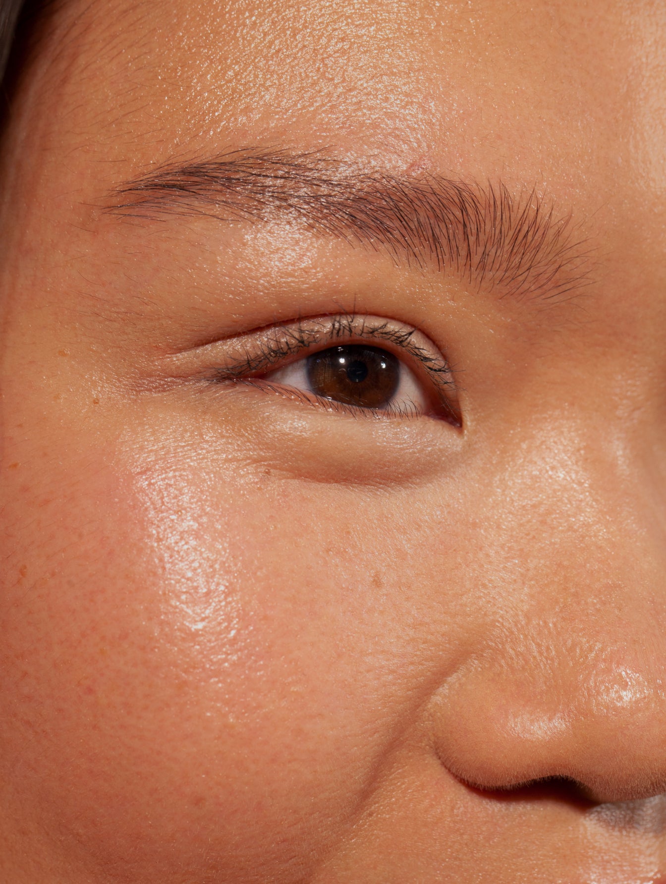 close-up of model wearing concealer in shade golden hour