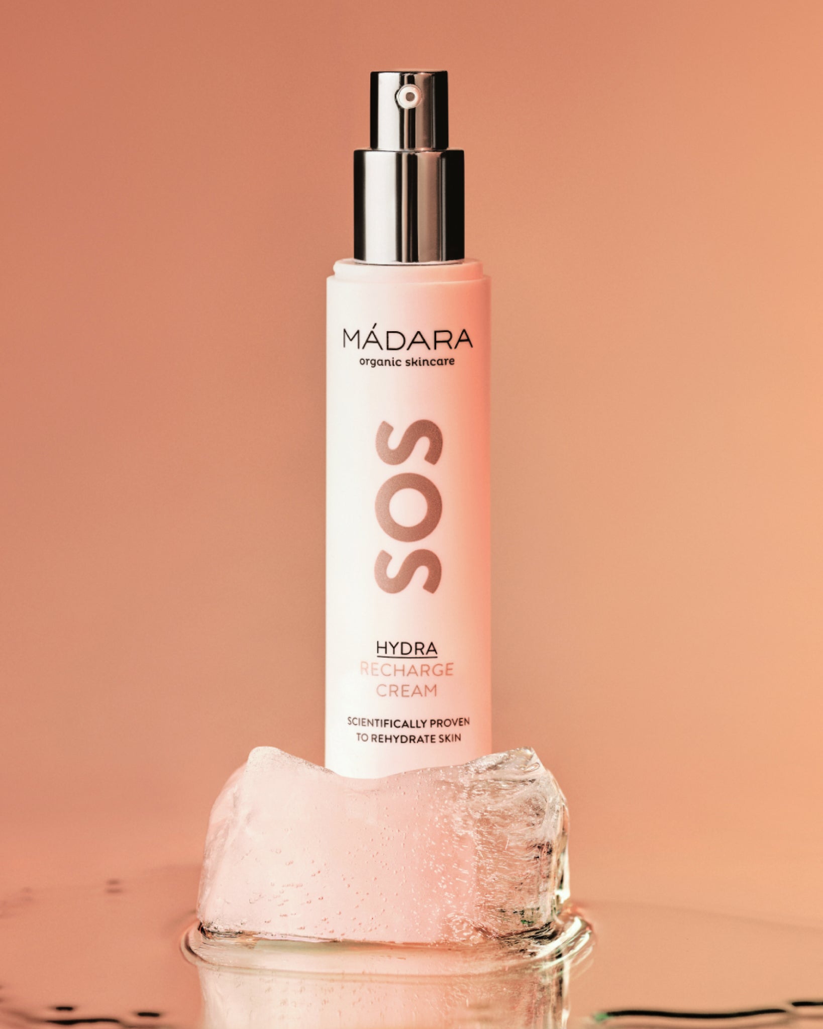 Mádara SOS Hydra Recharge cream bottle on a peach background
