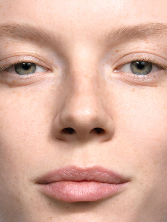 Madara H2O Hyaluron Tinted Serum model wearing shade may flower