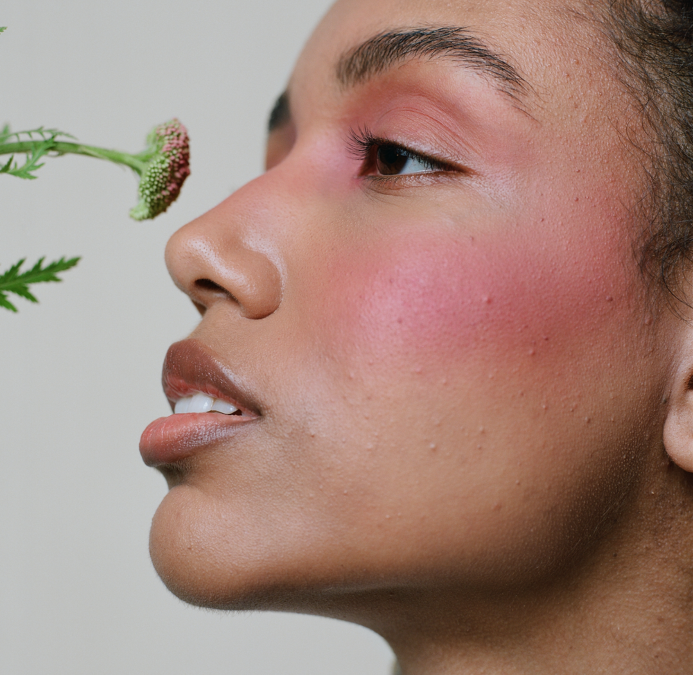 Close-up of a model’s face with soft pink cheeks enhanced by MÁDARA Magnetic Blush Mineral Cheek Blusher, with a natural radiant finish