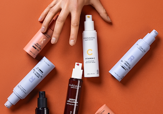 MÁDARA skincare set featuring vitamin C cream, retinol alternative and silk hair mist with sprouting plant on blue background representing renewal and glow category banner