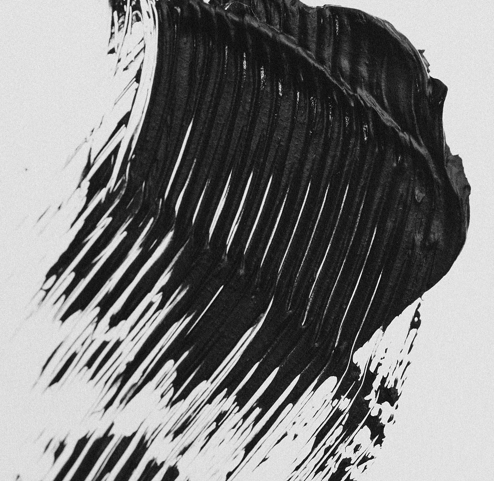 Jet-black mascara texture swipe showing rich pigment, buildable volume effect, and defining lash separation