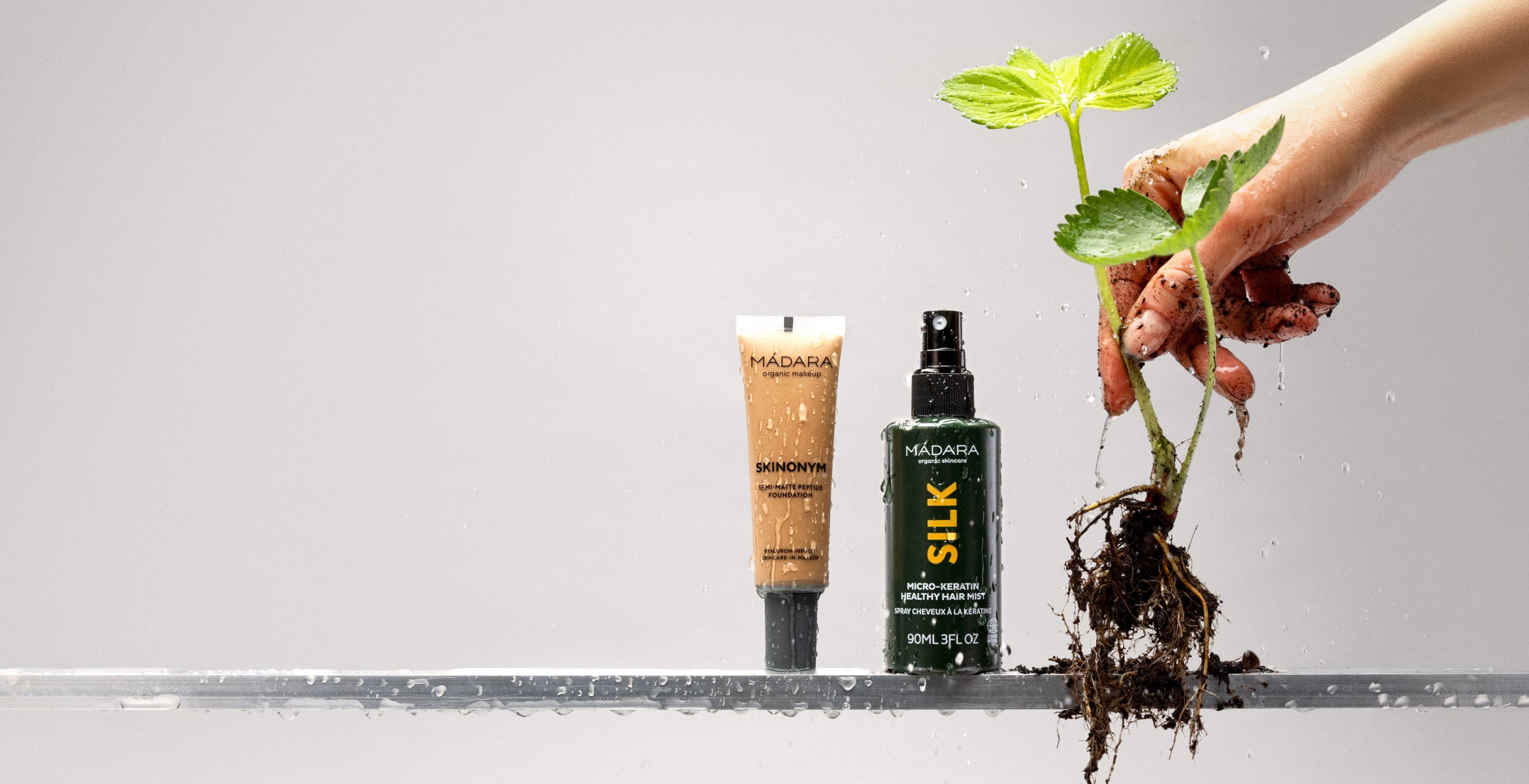 MÁDARA Skinonym foundation and Silk hair mist with fresh plant roots and water droplets highlighting natural beauty sale