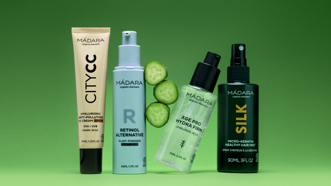 MÁDARA skincare products including City CC cream, retinol alternative, Hydra Firm serum and hair mist on green background with fresh cucumber slices category banner