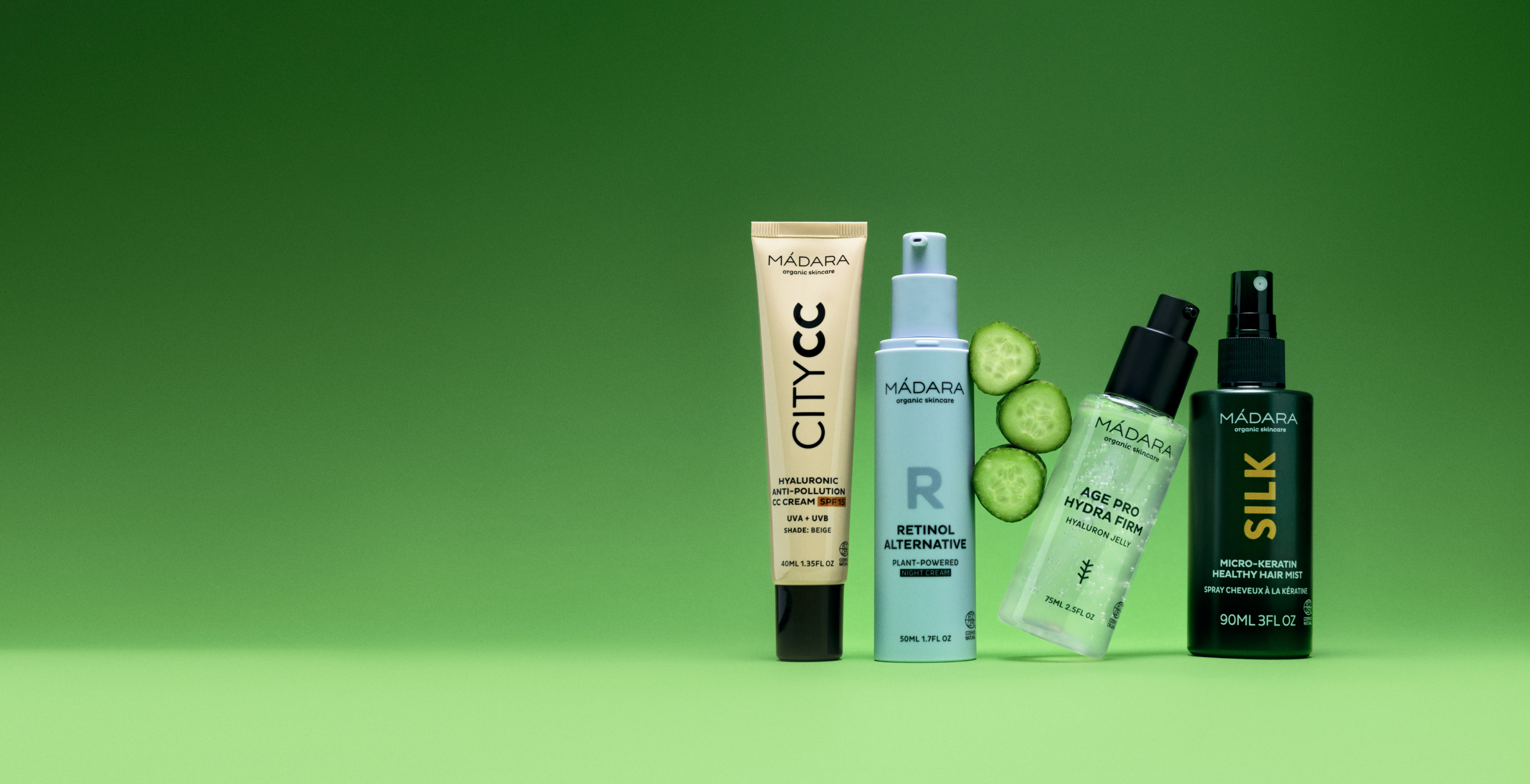 MÁDARA skincare products including City CC cream, retinol alternative, Hydra Firm serum and hair mist on green background with fresh cucumber slices homepage banner