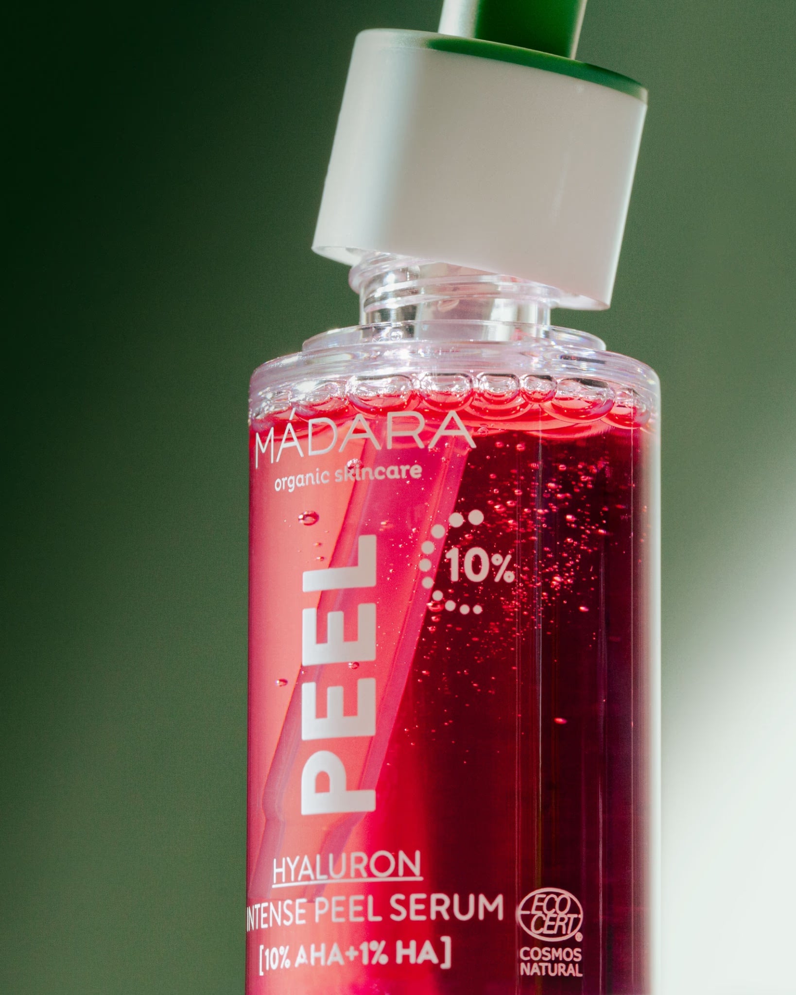 A close-up of a bottle of Madara Organic Skincare Hyaluron Intense Peel Serum.
