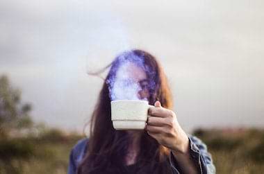 Girl with coffee cup outdoors