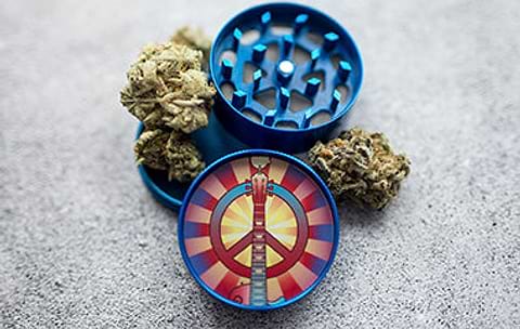 Blue herb grinder with peace symbol