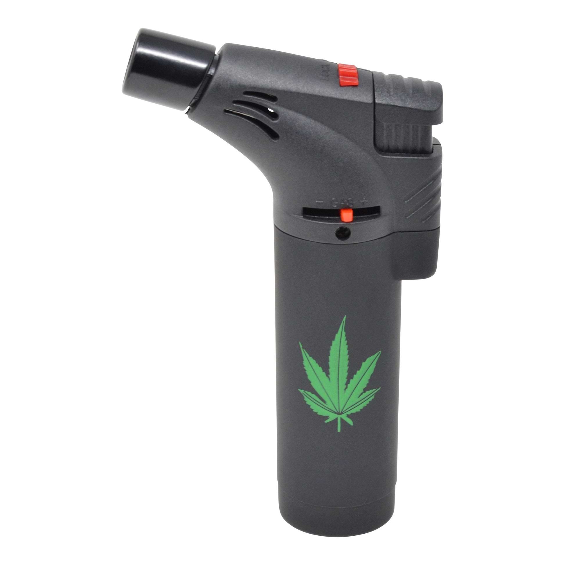 Full shot of black flame torch lighter with center green weed leaf design nozzle facing left