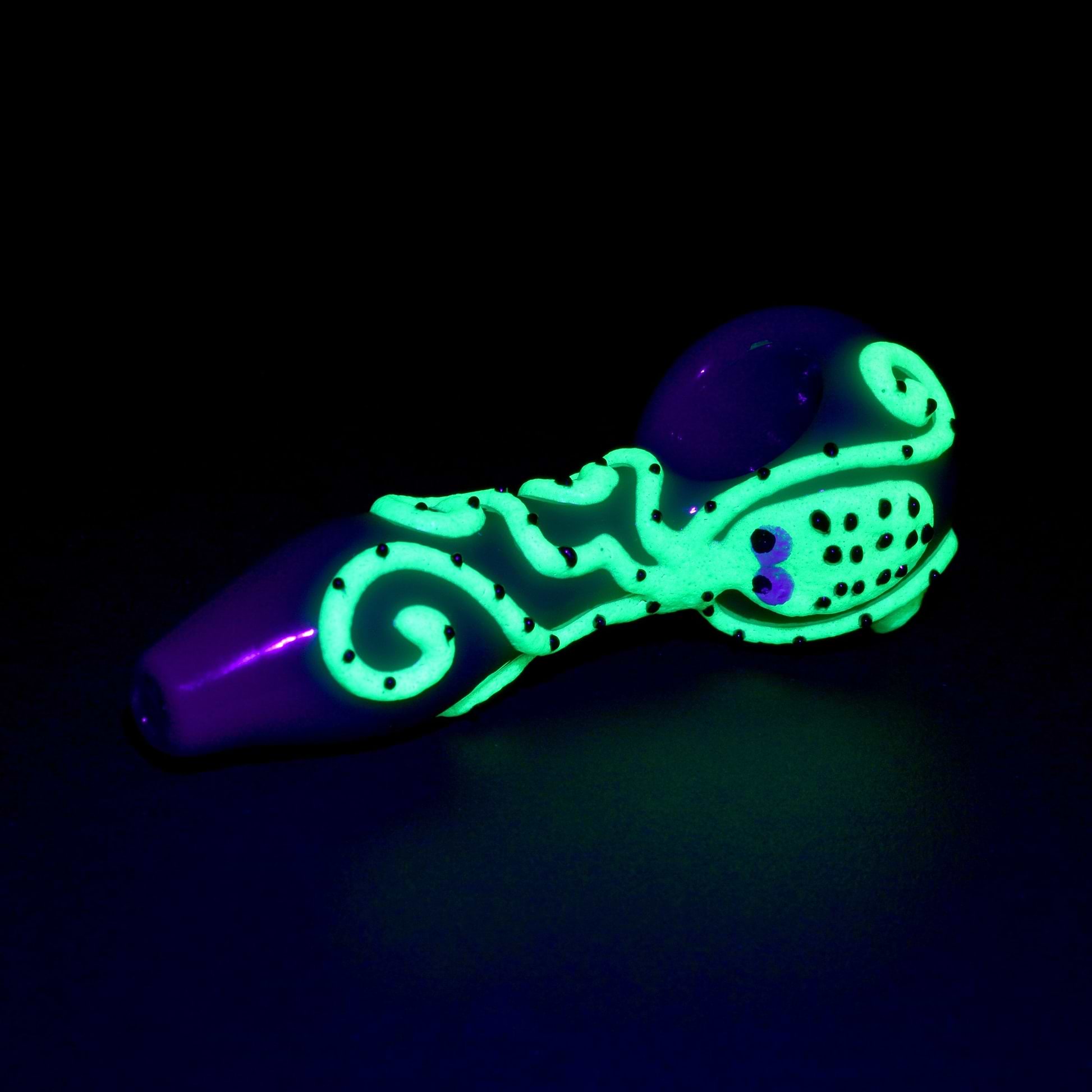 Full shot 4 inch green pipe bowl on the right glow in the dark dotted green octopus big eyes design dark background