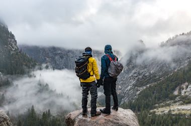 Two hikers overlooking Yosemite Valley