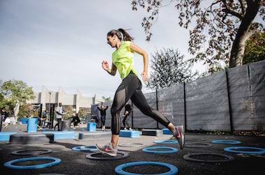 Woman running at outdoor gym
