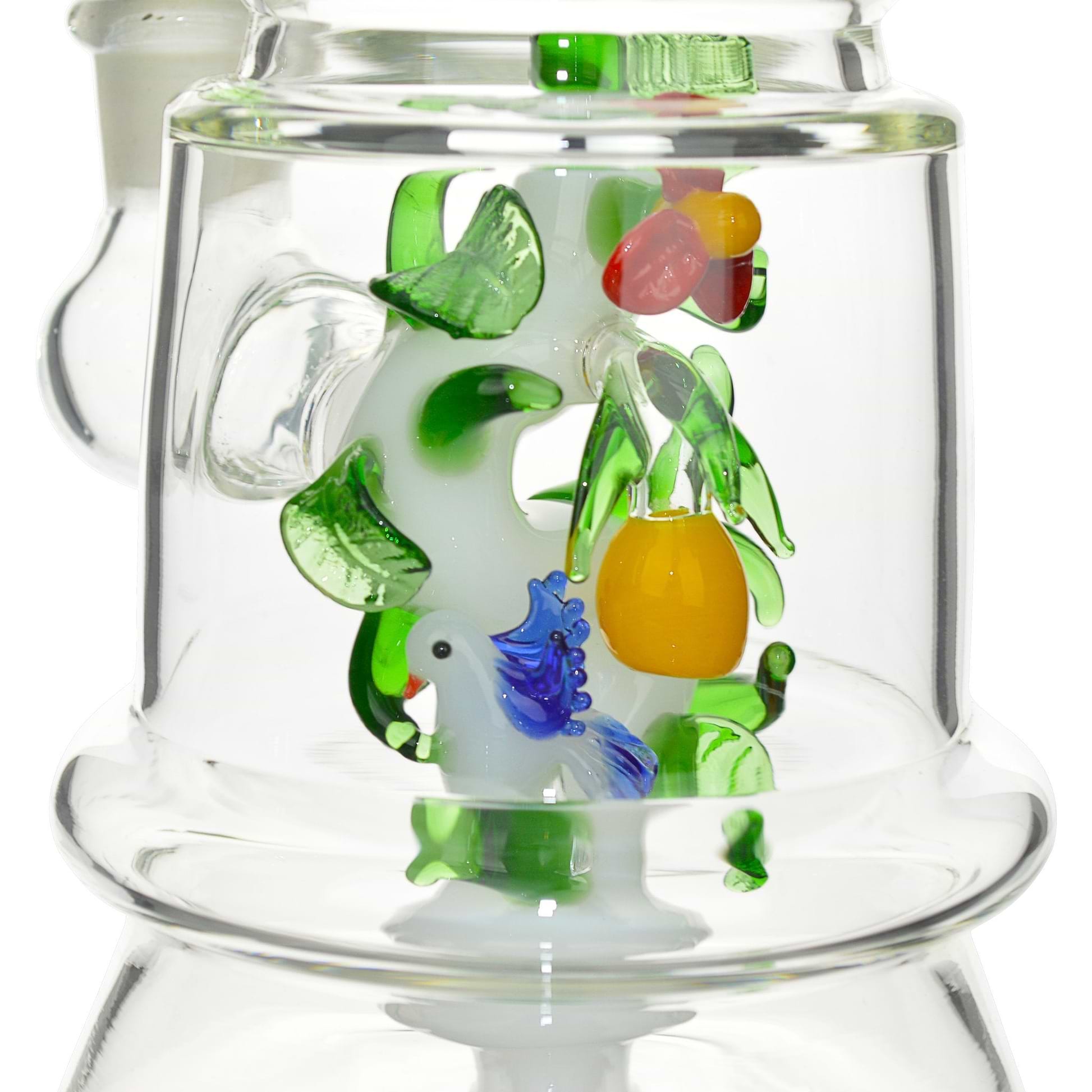 Close up glass smoking device with leaves tropical fruit, parrot bird centerpiece lab shape tropical paradise look