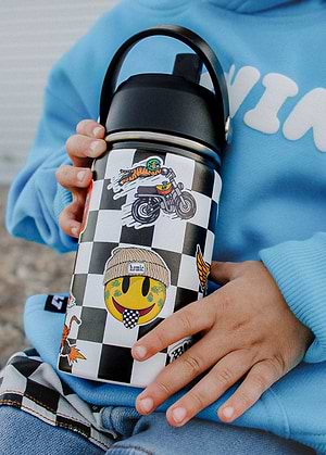 Kid holding a Little Trouble Checkered Sticker Slap Water Bottles, wearing a blue hoodie.