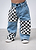 Little Trouble Checkered Patch Baggy Jeans - Blue jeans with checkered patches worn by a kid on a plain background