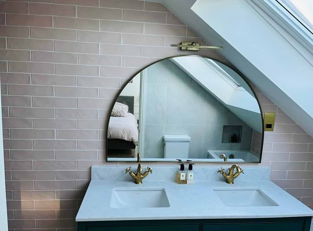 The new vanity is topped with an arched mirror - tiles by Hyperion Tiles