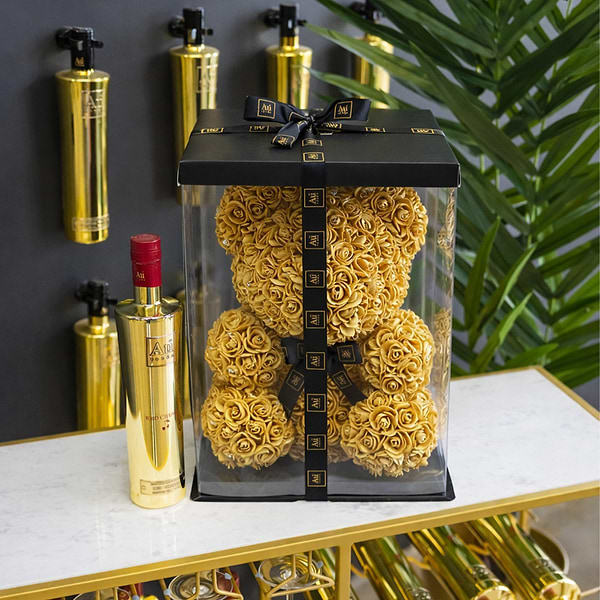Gold Roses forming the Shape of a Bear, in a Black Gift Box, with Au Vodka Branding. Next to a Bottle of Au Vodka Red Cherry