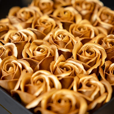 Close-up of gold roses in a gift box