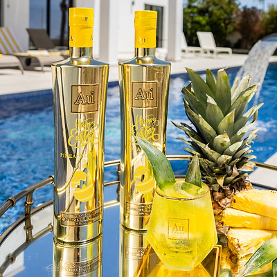 Two Bottles of Au Vodka Pineapple Crush, with Easter Design Printed on the Bottles. Next to a outdoor Pool.