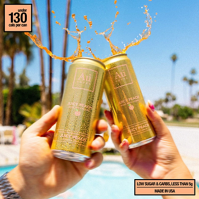 Two Au Vodka USA Juicy Peach cans clinking with liquid splashing out, poolside