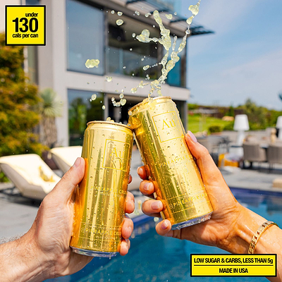 Two hands clinking Au Vodka USA Pineapple Crush cans with liquid splashing out, by a pool