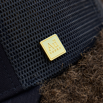 Gold square logo on the side of the cap
