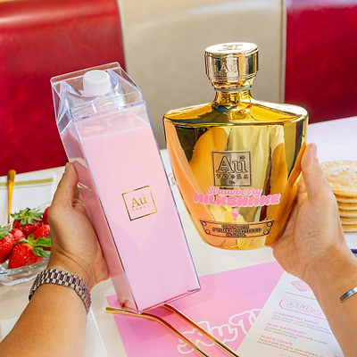 Gold strawberry milkshake and cocktail carton in diner setting