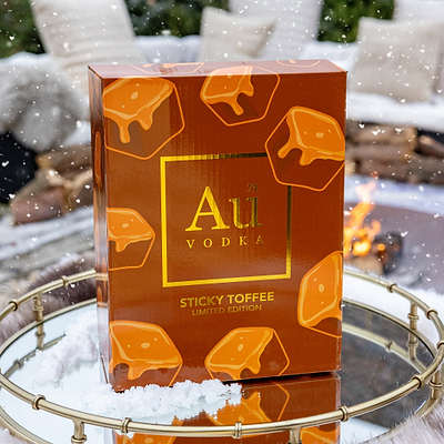 Au Vodka Sticky Toffee packaging with a snowy background