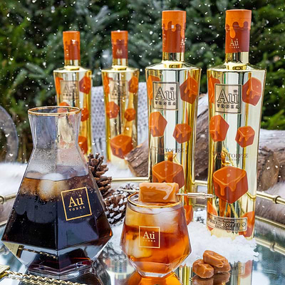 Au Vodka bottles and glasses with a winter background