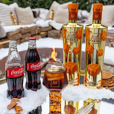 Wax dipped sticky toffee bottles next to a sticky diamond glass