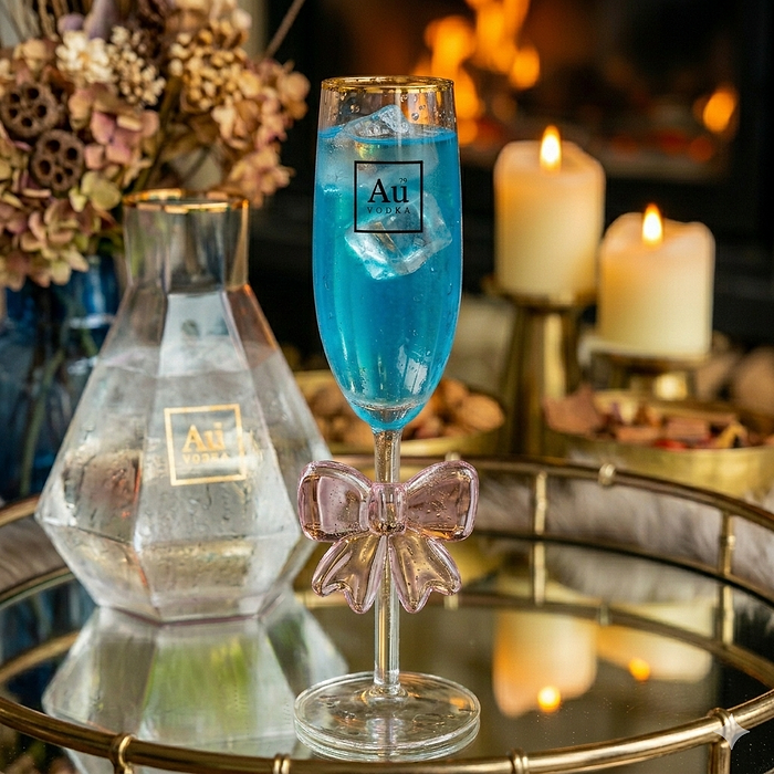 Au Vodka Glassware with a Hand-blown ribbon design, filled with a Blue Liquid. 