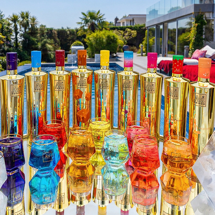 Au Vodka USA bundle with 10 gold bottles of vodka and 10 colorful glasses filled with drinks