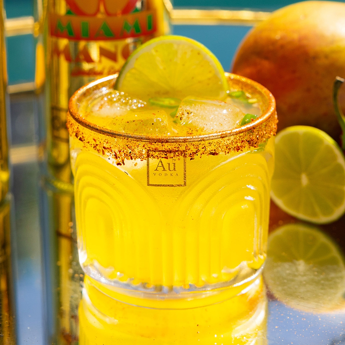 Au Vodka USA mango cocktail with a lime wedge and chili salt rim