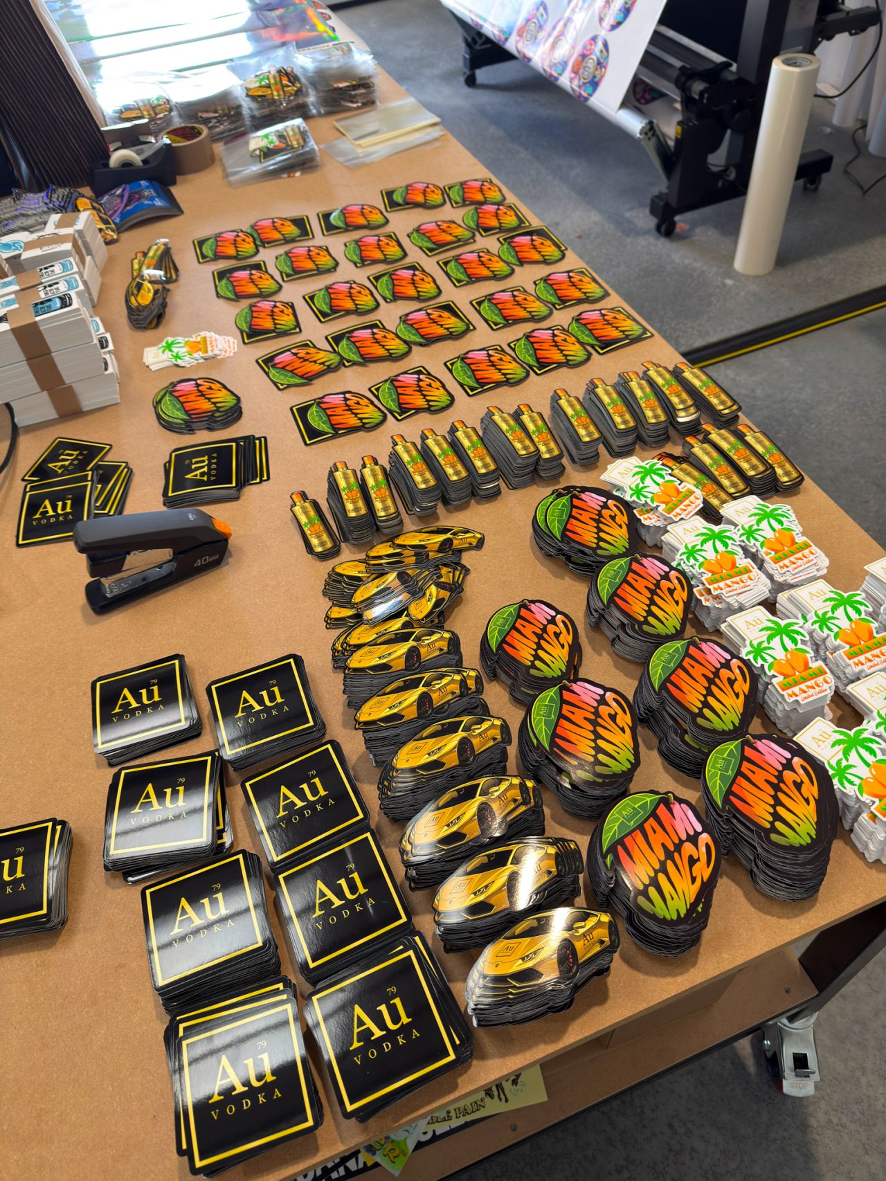 Table with various branded items including 'Au' and colorful packages.