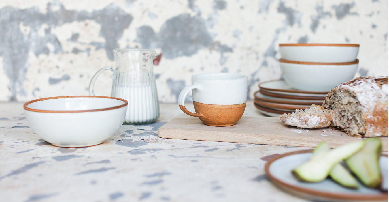 Bowl, mug and jug of milk