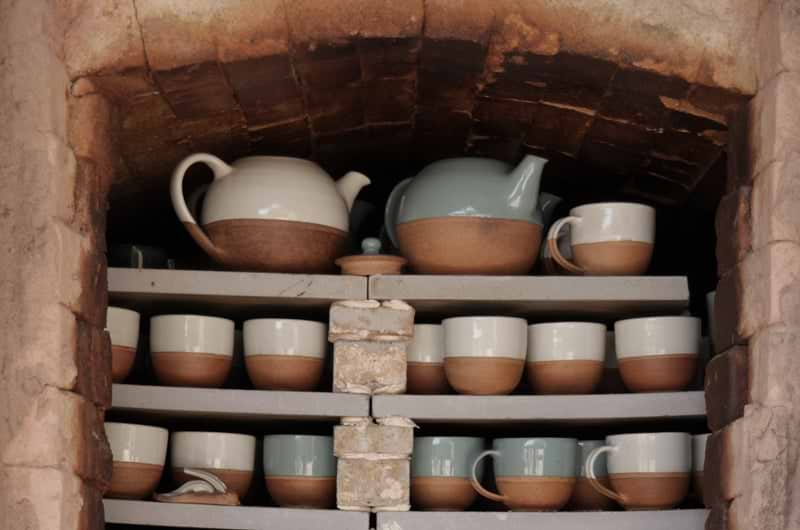 Glazed pots set out on shelves