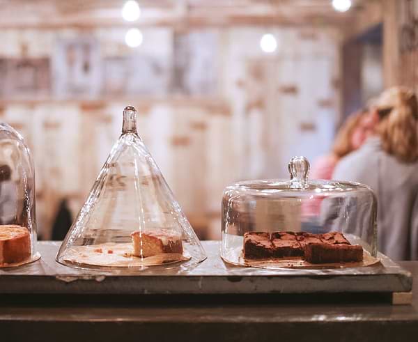 Cakes displayed in large glass domes