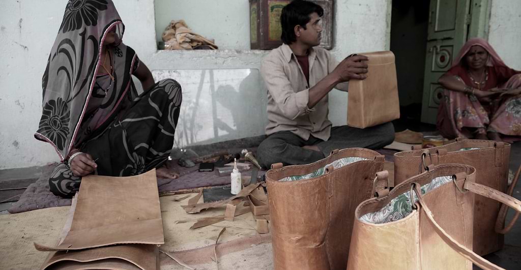 Indian artisan hand making a leather bag