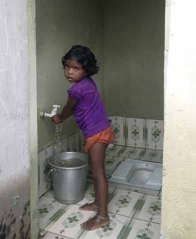 Young Indian child washing her hands