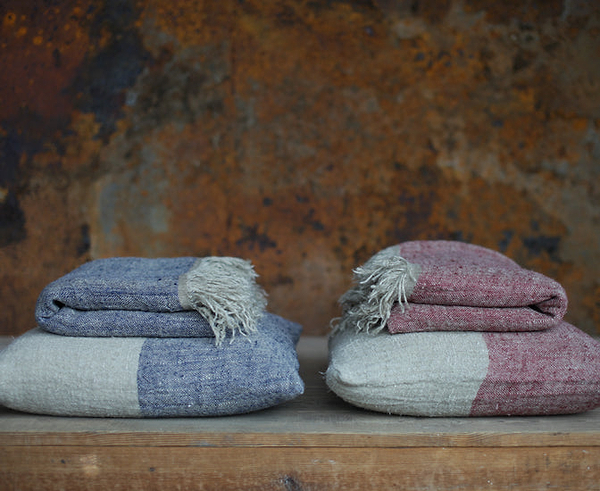Textured linen cushions and throws in red and blue