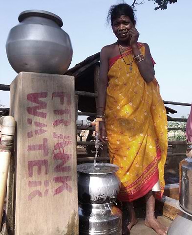 Indian woman taking water from a well