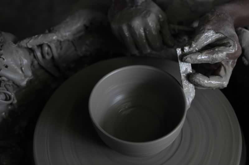 potter making pots on wheel