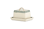 The nkuku Juniper Drop Butter Dish - Cream & Juniper features a rectangular ceramic design with a cream lid edged in green drops and a curved handle, offering both charm and elegance to your table.