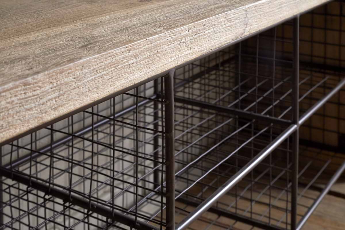 Close-up of the nkuku Abha Reclaimed Wood & Iron Storage Bench - Natural, highlighting the textured wood tabletop and the metal grid shelves beneath, ideal for use as a shoe storage bench or entryway organizer.
