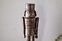 The Imay Nutcracker - Antique Brass by nkuku features a wooden soldier with a cylindrical hat, round eyes, and a mustache in a detailed uniform—ideal for festive styling or as part of your decorative nutcracker display.