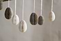 The nkuku Piani Mini Hanging Paper Decoration set includes 12 natural and moss-colored honeycomb eggs crafted from recycled paper, beautifully suspended from strings for stylish décor.