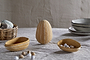 The nkuku Surya Recycled Cotton Paper Side Opening Egg in ochre & cream brings eco-friendly charm to your Easter table, standing upright with white stripes—pair with matching bowls and a woven basket for delightful seasonal gifting.