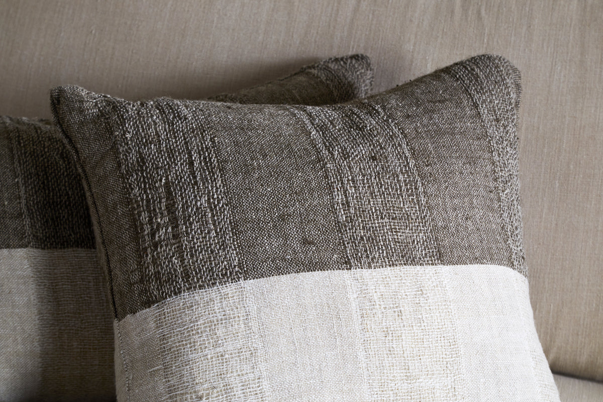 A close-up of the nkuku Munir Linen Cushion Cover in Charcoal, featuring a slubby textured finish.