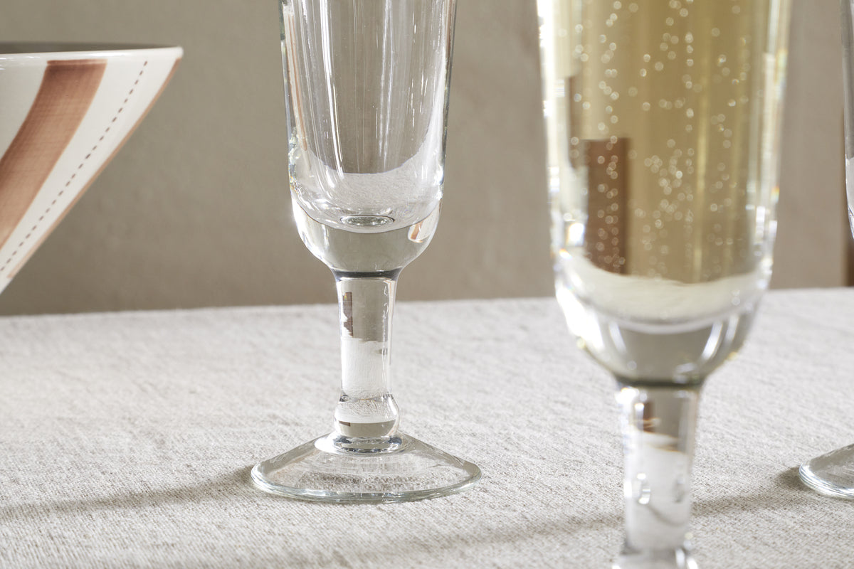 A close-up of the nkuku Pani Champagne Flute - Clear (Set of 4), highlighting its elegant design as part of a refined glassware collection.