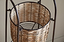 A close-up of the Montali Iron & Rattan Three-Tiered Storage Stand by nkuku shows its handwoven rattan baskets with round, crisscross patterns set in a dark metal frame—ideal for kitchen or pantry organization.